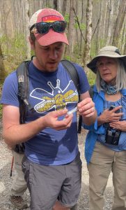 Will Kuhn, director of science and research for Discover Life in America, examines a specimen collected during the 2023 Great Smokies Eco-Adventure. Providing fascinating information on each of the species observed on the trail, the entomologist and adventure guide has the unique ability to get anyone interested in insects, said fellow guide Jaimie Matzko. Photo provided by Jaimie Matzko.