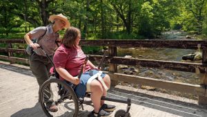 Katie Corrigan checks in with a program participant during a hike and boat tour at Hazel Creek this month. Photo provided by Jim Matheny, Friends of the Smokies. 