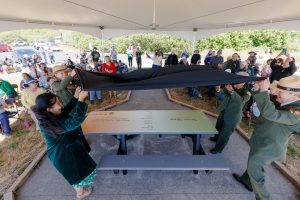 US Poet Laureate Ada Limón, National Park Service Education Strategist Shauna Potocky, and California State Parks North Coast Redwoods District Superintendent Shelana DeSilva unveil a poetry installation at Redwoods National and State Parks June 23. Photo provided by Shawn Miller, Library of Congress.