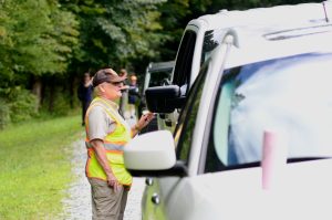 Luftee Rover Liz Wilson speaks with a visitor parked along US 441 to view elk grazing in the Oconaluftee area. Interacting with people is one of her favorite parts of this volunteer job. Photo provided by Holly Kays, Smokies Life.