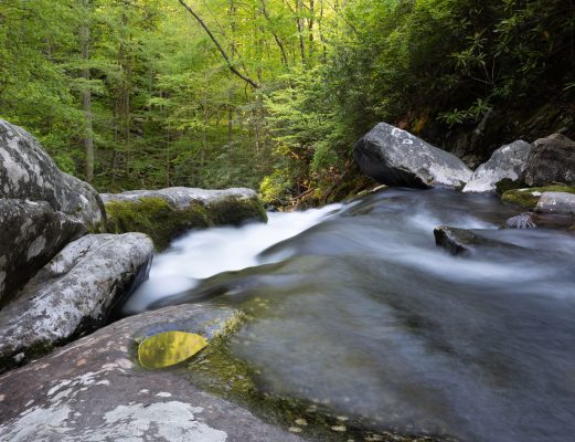 The bright greens of the canopy above this unnamed falls are reflected in a small pool in the rocks beneath the falls, introducing color and providing some balance in the lower portion of the frame. Canon EOS R5 + Canon RF 14-35mm f/4 L IS USM at 27mm, f/16, 2s, ISO100. Provided by Michele Sons.